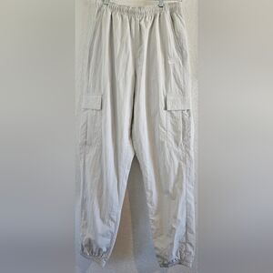 Nike Men's Standard Fit Taper Leg Pants in a light grey or "Platinum" color